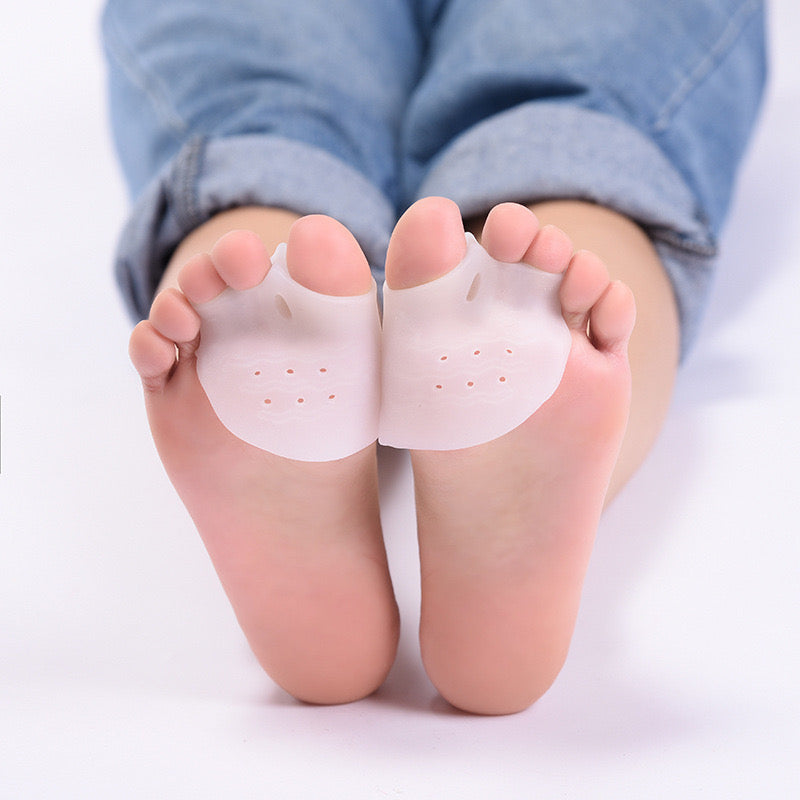 best bunion correctors for women - Silicone foot pads on a person's feet with rolled-up jeans.
